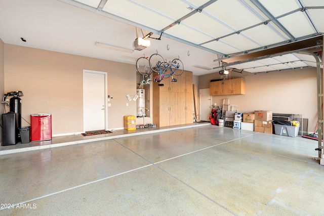 garage with a garage door opener and water heater