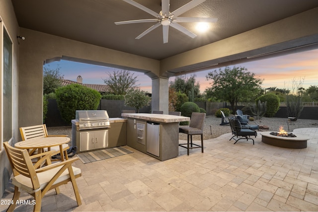 2378 N 158th Dr, Goodyear, AZ 85395 - fenced backyard featuring a fire pit, a patio, ceiling fan, and exterior bar
