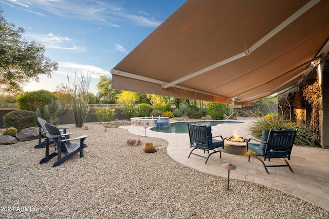 view of patio / terrace featuring a fenced in pool and a fire pit