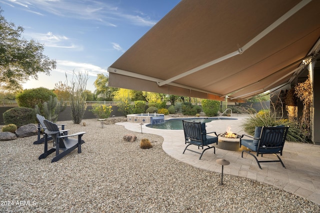 2378 N 158th Dr, Goodyear, AZ 85395 - fenced backyard featuring an outdoor fire pit, a patio area, and a pool with connected hot tub