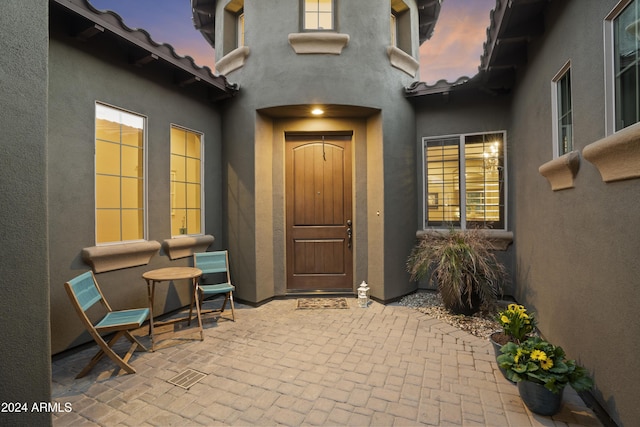 2378 N 158th Dr, Goodyear, AZ 85395 - view of exterior entry with stucco siding and a patio
