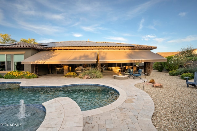 back of property featuring a patio and pool water feature