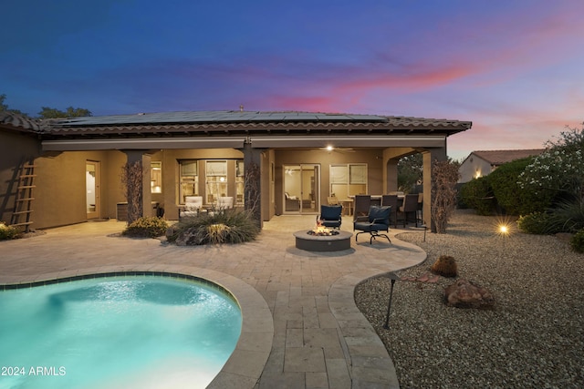 2378 N 158th Dr, Goodyear, AZ 85395 - rear view of property featuring an outdoor fire pit, a patio, solar panels, and an outdoor pool