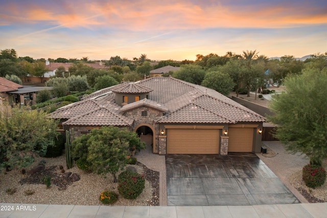 mediterranean / spanish-style house with a garage