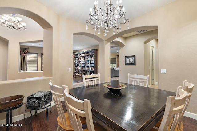 2378 N 158th Dr, Goodyear, AZ 85395 - dining area featuring arched walkways, wood finished floors, a chandelier, and baseboards