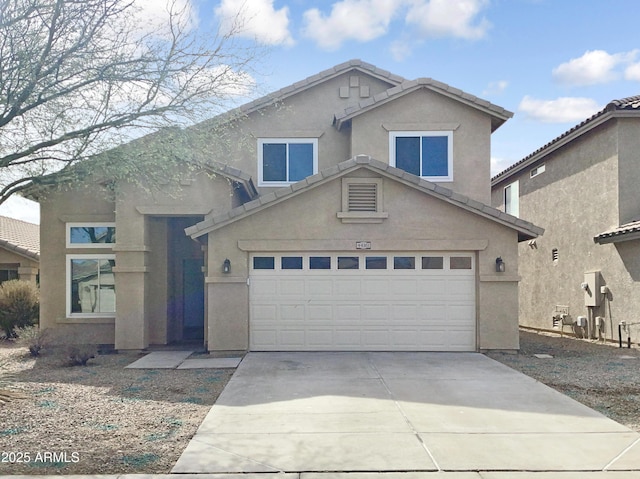 traditional home with a garage, driveway, a tile roof, and stucco siding