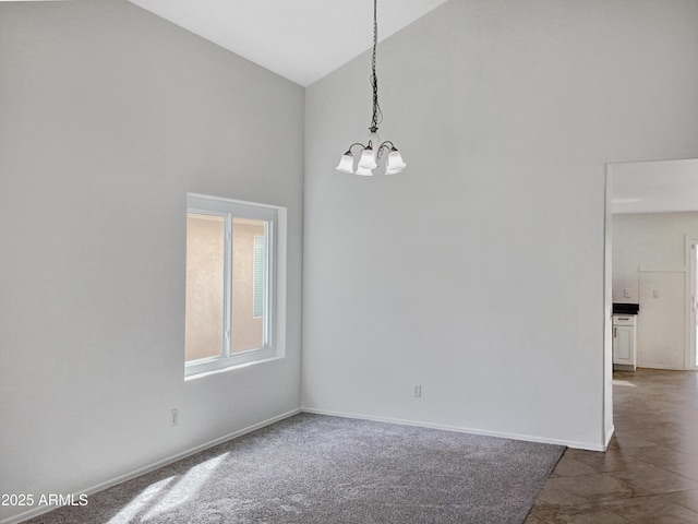 empty room featuring a chandelier, high vaulted ceiling, and baseboards