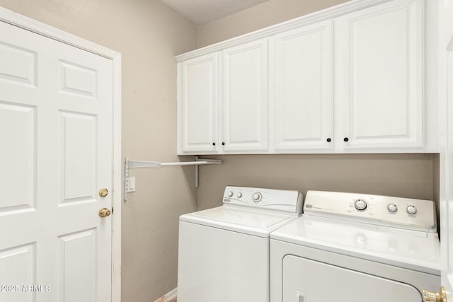 laundry area featuring cabinet space and washing machine and clothes dryer