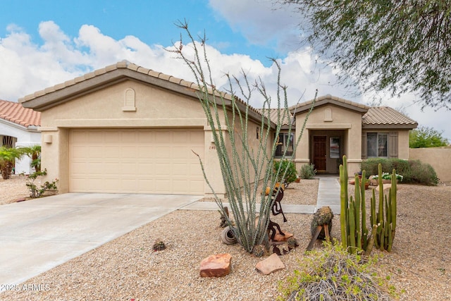 mediterranean / spanish-style home with a tiled roof, a garage, driveway, and stucco siding