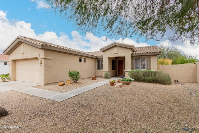 view of front facade featuring fence, driveway, stucco siding, a garage, and a tiled roof