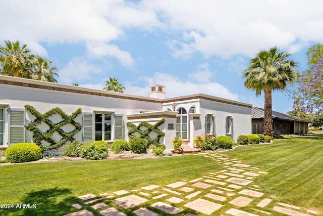 back of house with a lawn