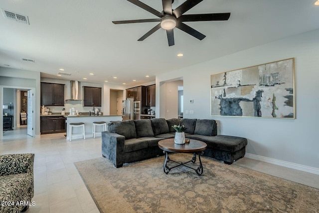 tiled living room with ceiling fan