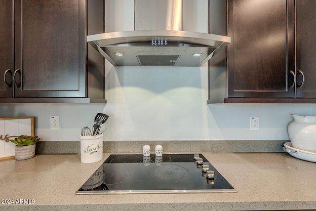 kitchen featuring black electric stovetop, dark brown cabinets, and extractor fan