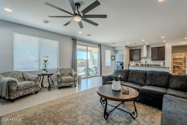 living room featuring ceiling fan and sink