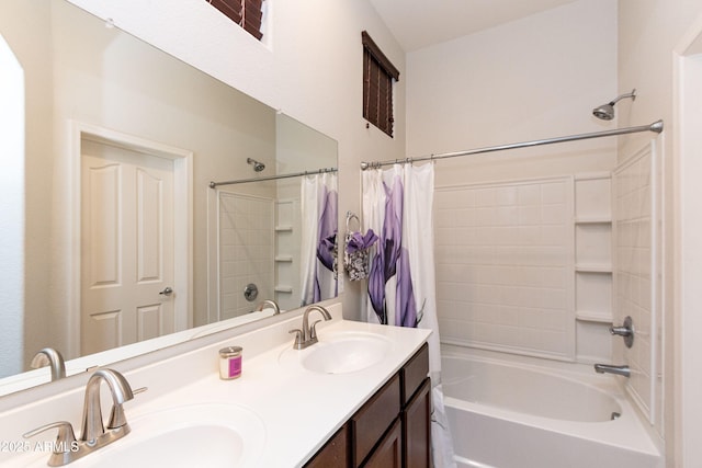 bathroom with double vanity, shower / tub combo, and a sink