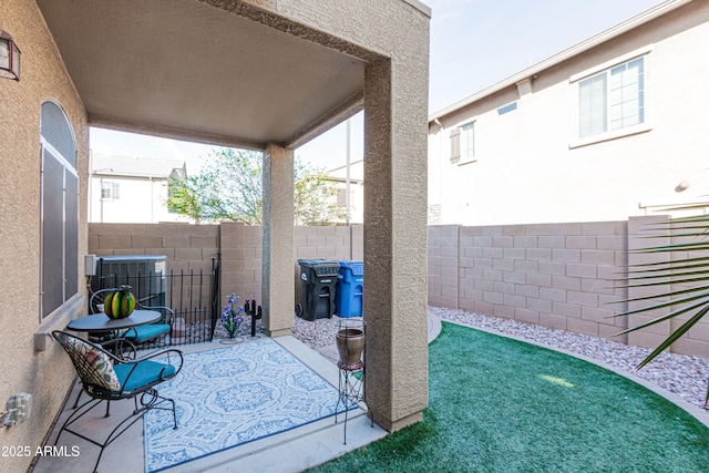 view of patio featuring central air condition unit and a fenced backyard