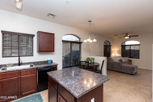 kitchen with a sink, visible vents, a center island, dishwasher, and dark countertops