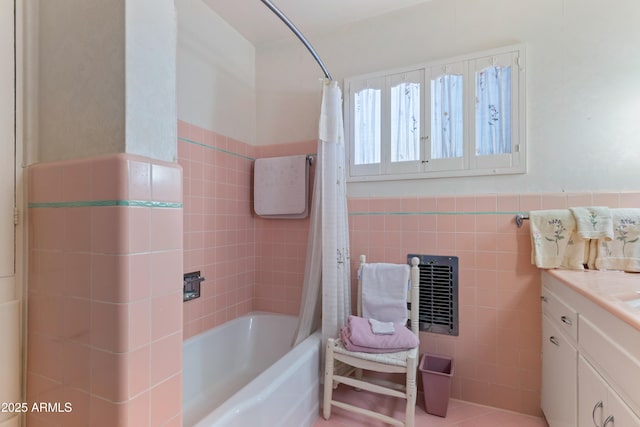 bathroom featuring vanity, heating unit, shower / tub combo with curtain, and tile walls