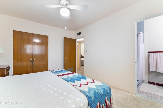 bedroom with ceiling fan, carpet floors, connected bathroom, and a closet