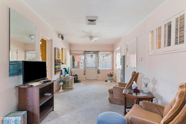 interior space with light carpet and ceiling fan