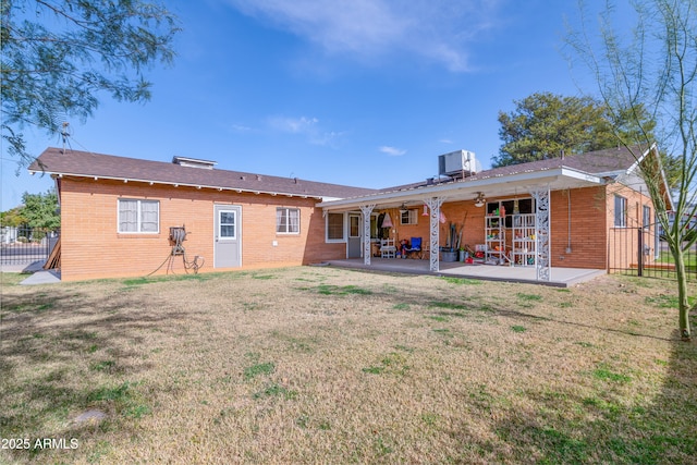 back of property featuring a patio, central AC unit, and a lawn