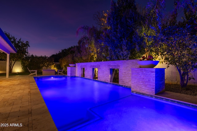 view of swimming pool featuring a patio and pool water feature