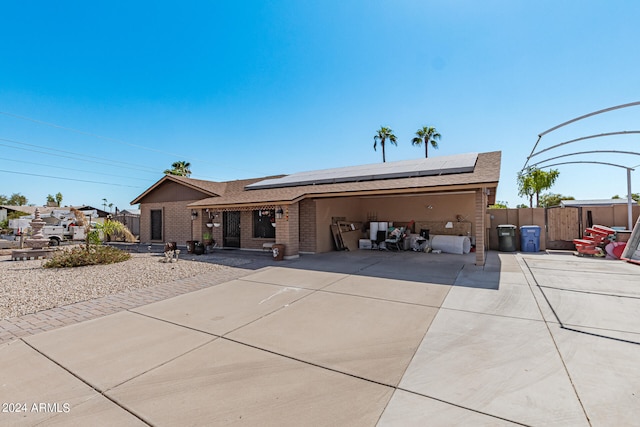 view of front facade featuring solar panels and a garage