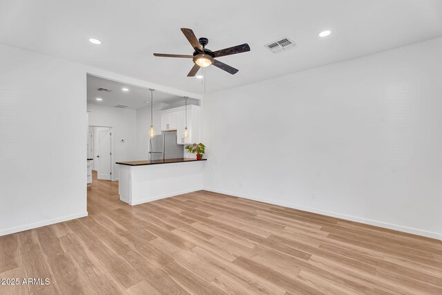 1306 E Fillmore St, Phoenix, AZ 85006 - unfurnished living room featuring a ceiling fan, light wood finished floors, recessed lighting, and baseboards