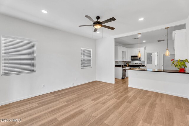 1306 E Fillmore St, Phoenix, AZ 85006 - unfurnished living room with light wood-style flooring, ceiling fan, recessed lighting, and baseboards