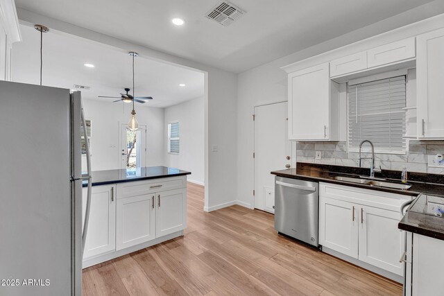 1306 E Fillmore St, Phoenix, AZ 85006 - kitchen with stainless steel dishwasher, freestanding refrigerator, a sink, light wood-style flooring, and ceiling fan