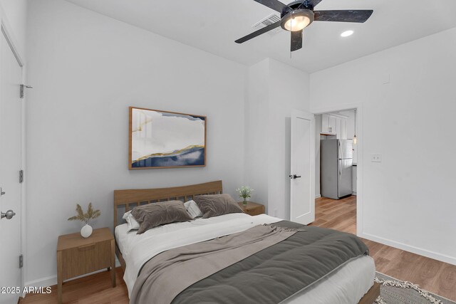 1306 E Fillmore St, Phoenix, AZ 85006 - bedroom with freestanding refrigerator, light wood finished floors, baseboards, recessed lighting, and ceiling fan