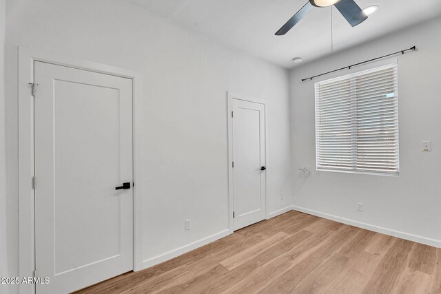 1306 E Fillmore St, Phoenix, AZ 85006 - unfurnished bedroom featuring light wood-type flooring, baseboards, and ceiling fan
