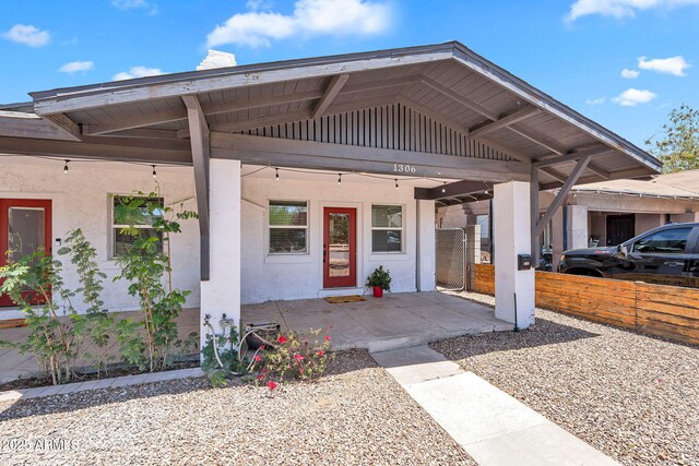 1306 E Fillmore St, Phoenix, AZ 85006 - view of front facade with a porch, stucco siding, and board and batten siding