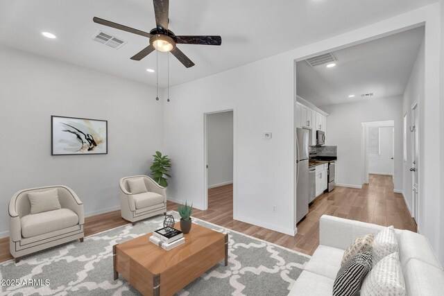 1306 E Fillmore St, Phoenix, AZ 85006 - living room featuring light wood finished floors, ceiling fan, baseboards, and recessed lighting