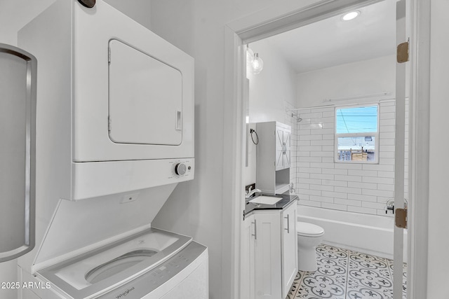 1306 E Fillmore St, Phoenix, AZ 85006 - bathroom featuring stacked washer / drying machine, toilet, vanity,  shower combination, and tile patterned flooring