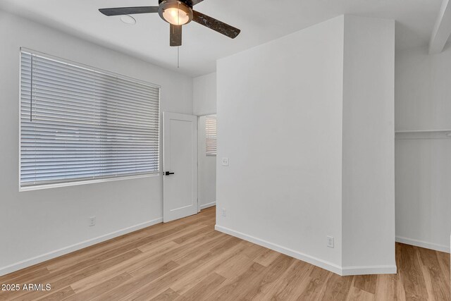 1306 E Fillmore St, Phoenix, AZ 85006 - unfurnished bedroom with light wood-style floors, baseboards, and ceiling fan