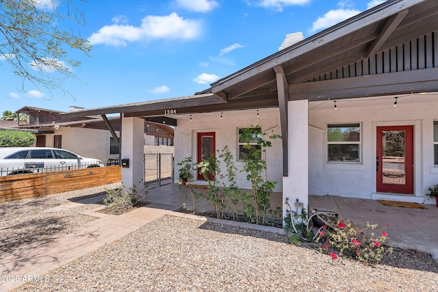 1306 E Fillmore St, Phoenix, AZ 85006 - property entrance with a chimney, stucco siding, and a gate