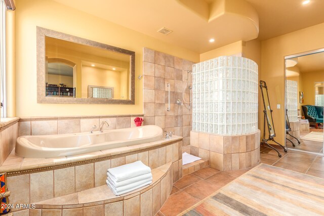 full bath featuring tile patterned flooring, visible vents, and a bath