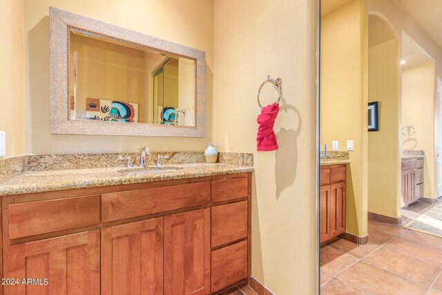 bathroom featuring tile patterned flooring, vanity, and baseboards