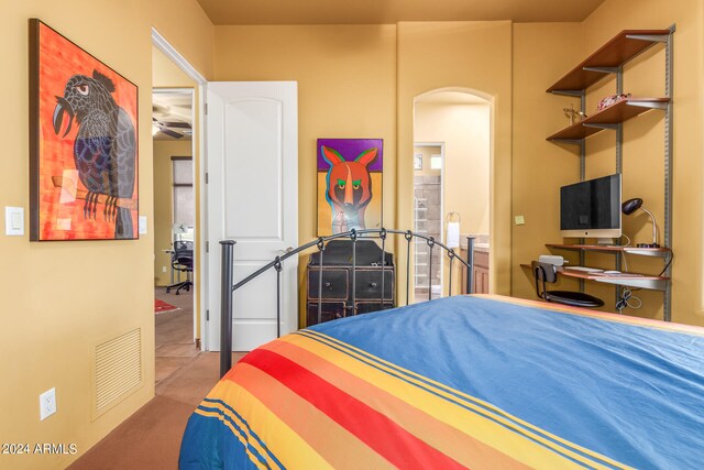 bedroom featuring visible vents and arched walkways