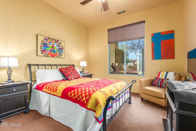 carpeted bedroom with visible vents and ceiling fan