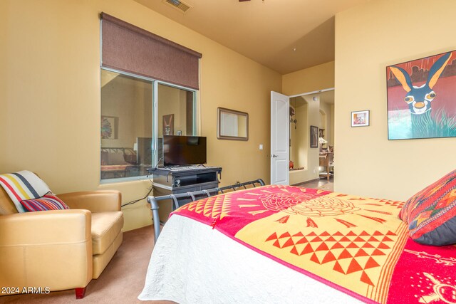 carpeted bedroom with visible vents and a closet