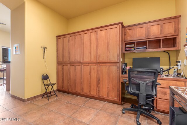 home office with light tile patterned floors and baseboards