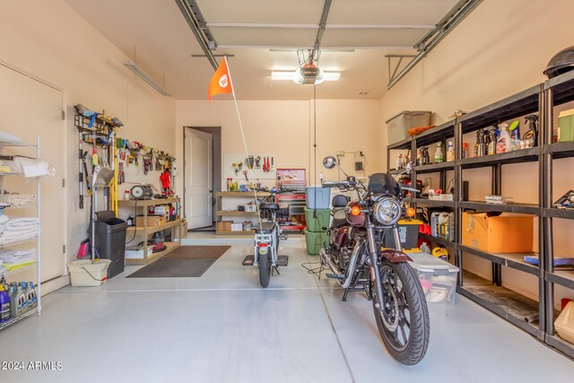 garage with a workshop area and a garage door opener