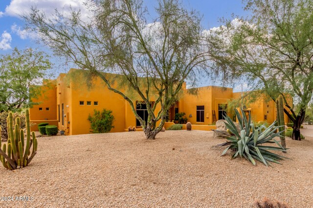 back of property featuring stucco siding