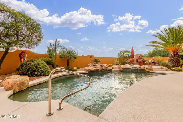 view of swimming pool featuring a fenced in pool, fence, and a patio