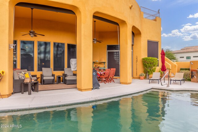 outdoor pool featuring a patio area and ceiling fan