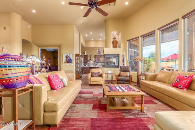 living room with ceiling fan, visible vents, and recessed lighting