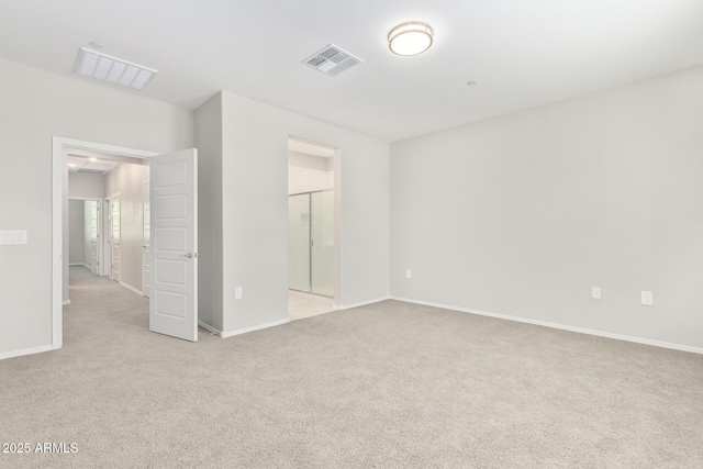 unfurnished bedroom with light carpet, ensuite bath, baseboards, and visible vents