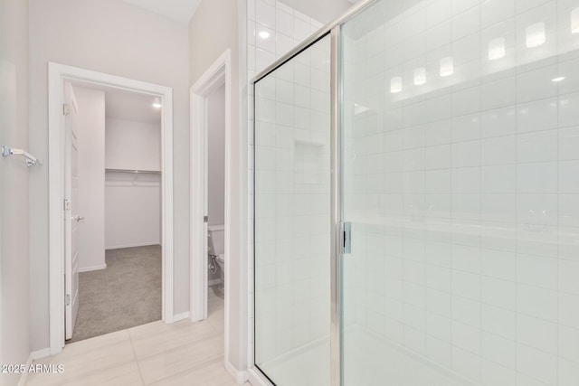 full bath featuring a shower stall and toilet